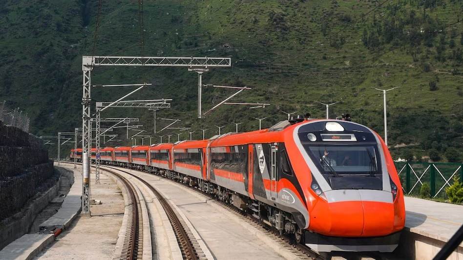 Vande Bharat Trains running through scenic mountains, showcasing India's high-speed rail network.